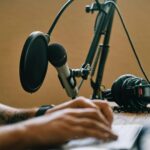 a man sitting talking on his podcast showing tips for podcasting success