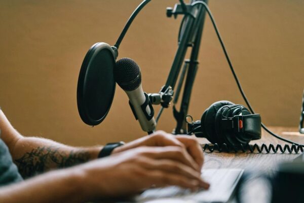 a man sitting talking on his podcast showing tips for podcasting success